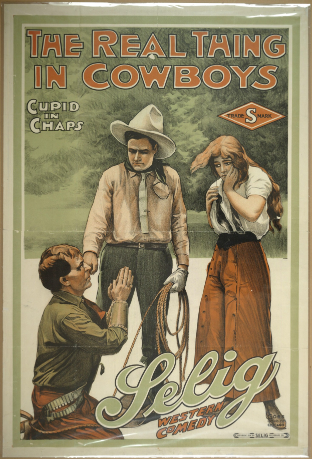 Plakat an einer Wand mit drei Personen, zwei Männer mit Cowboyhüten und eine Frau in einem langen Kleid, mit der Aufschrift "Das echte Ding bei Cowboys" in fetter schwarzer Schrift auf einem hellgelben Hintergrund.